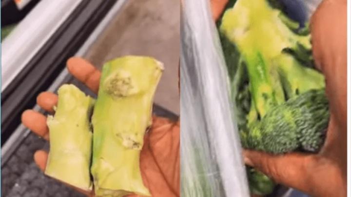 Mujer corta tallos de verduras antes de pagar en la tienda