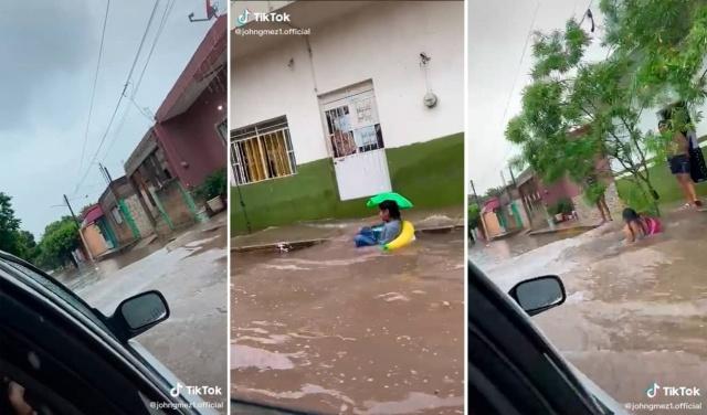 Niños juegan con flotadores tras inundaciones.